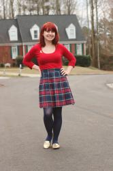 A Holiday Outfit: Red Sweater with a Plaid Pleated Skirt and Glittery Gold Loafers