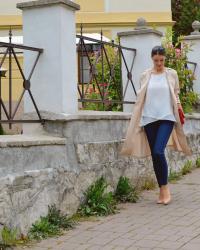 long beige trench coat with red bag