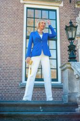 White flared trousers with a bright blue jacket