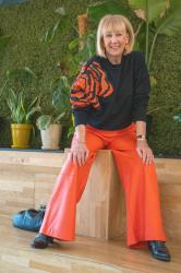 Orange pleather trousers and sequinned sweater