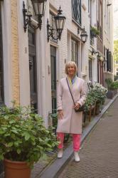 Pink trousers with a multicoloured jumper and Milan