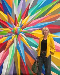 Golden yellow blouse as a jacket against murals